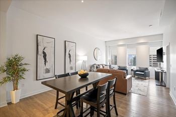 Furnished short-term rental living and dining area at sky on main